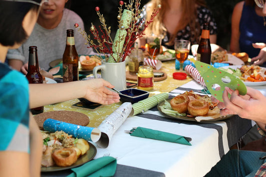 A group of friends gathered around a dining table, enjoying party appetizers