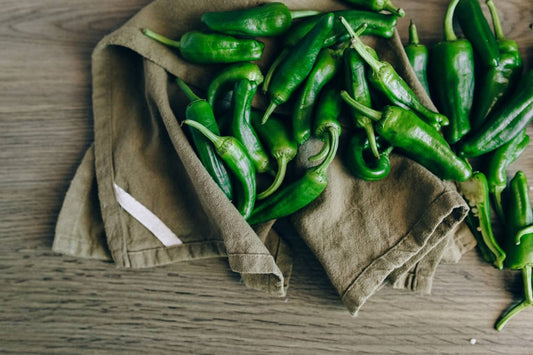 A pile of fresh, green jalapeno peppers