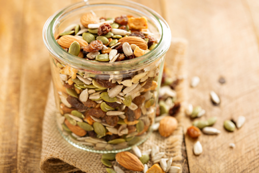 A glass jar full of healthy trail mix