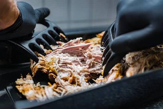 pulled pork being prepared in a pan
