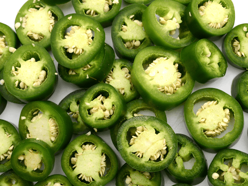 A close-up of freshly sliced jalapeno pieces